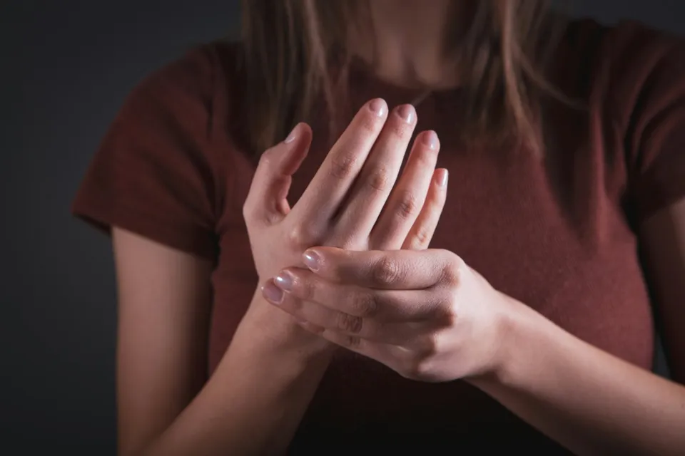 Woman holding her sore wrist, typical symptom of carpal tunnel syndrome