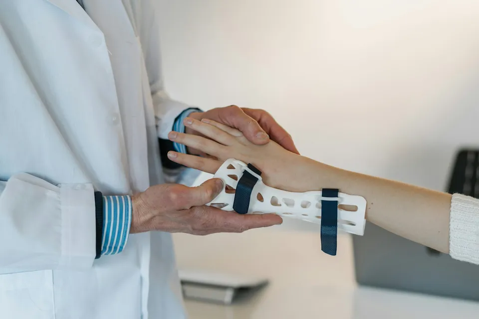 Doctor examining a patient's hand, medical consultation