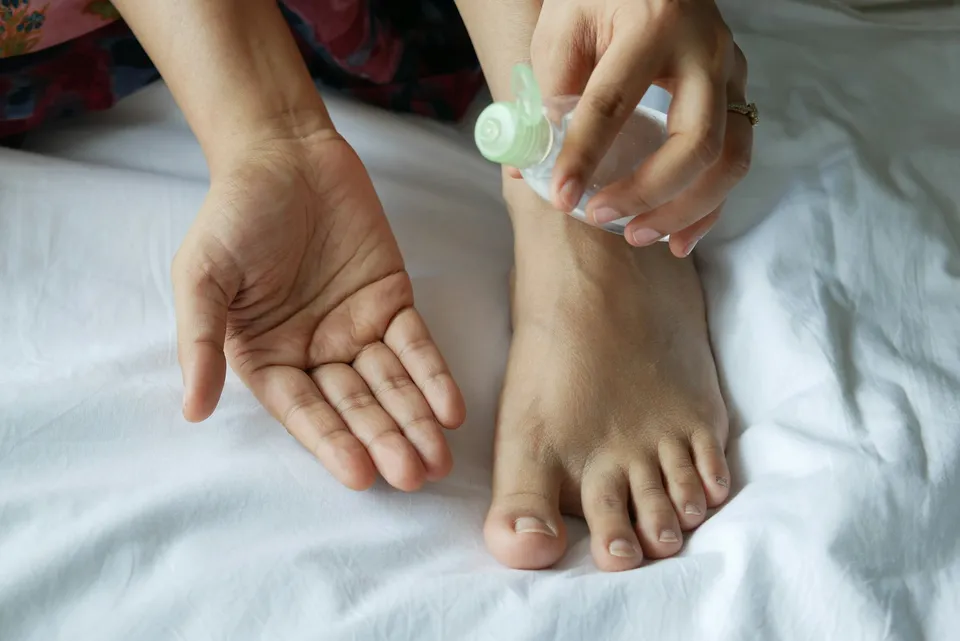 Moisturizing care applied to a foot, skincare routine for soft feet
